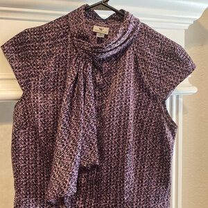 Structured blouse with geometric details in purple and black. Size M